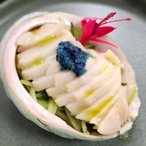 An entree of abalone served with with blue scampi caviar, finger lime, cucumber, coconut water and herb oil - by chef Spencer Patrick for Taste of Port Douglas.